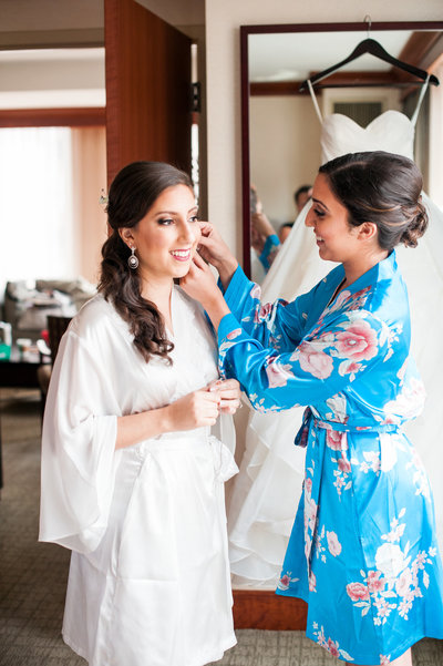 Serbian bride in luxury Washington DC wedding getting dressed with bridesmaid