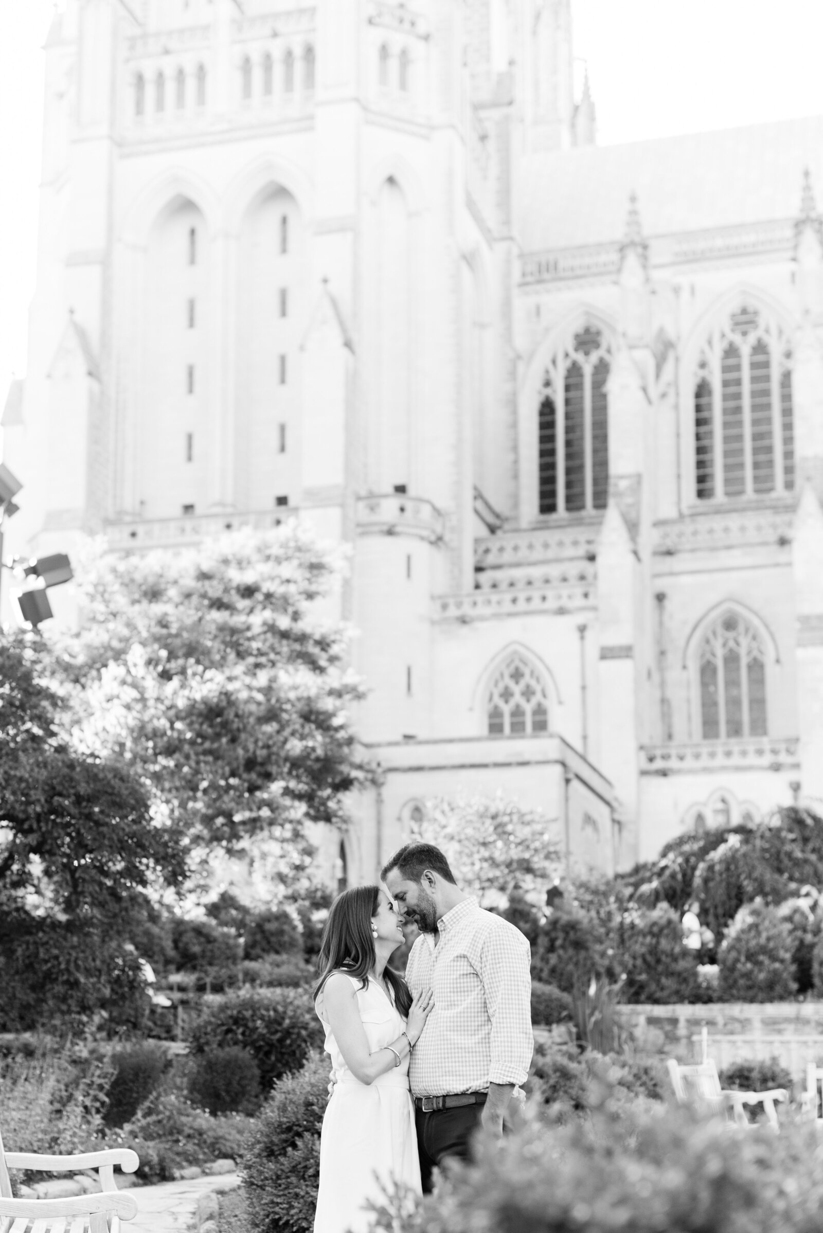 engaged couple taking engagement photos at National Cathedral engagement session