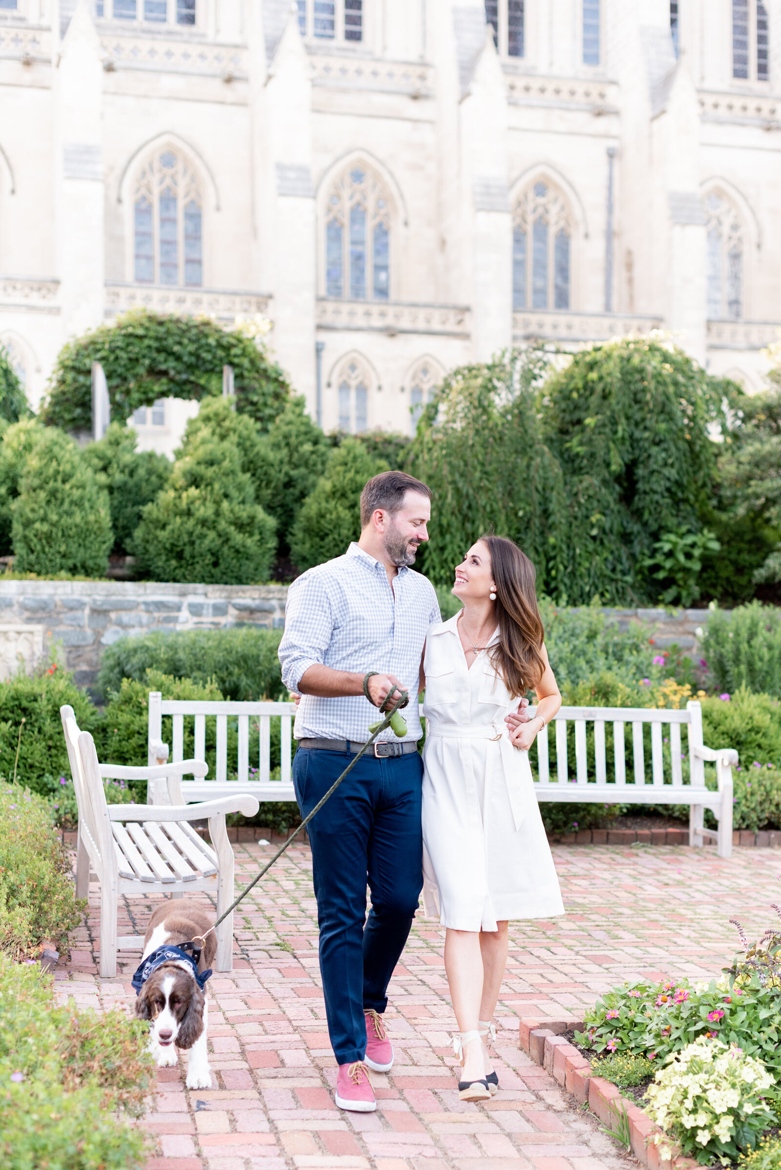 engaged couple taking engagement photos at National Cathedral engagement session