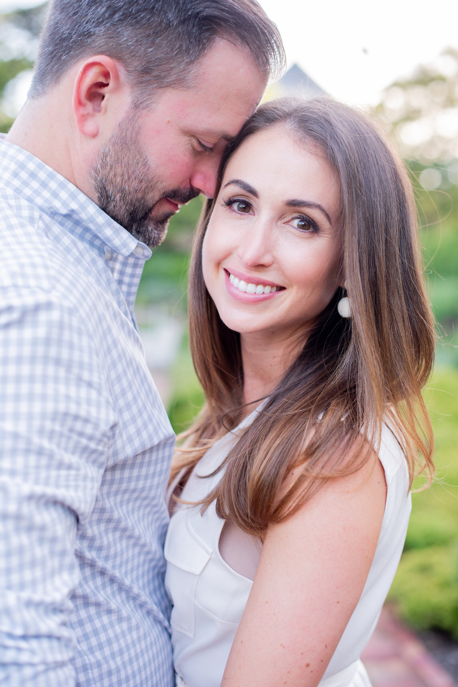 engaged couple taking engagement photos at National Cathedral engagement session