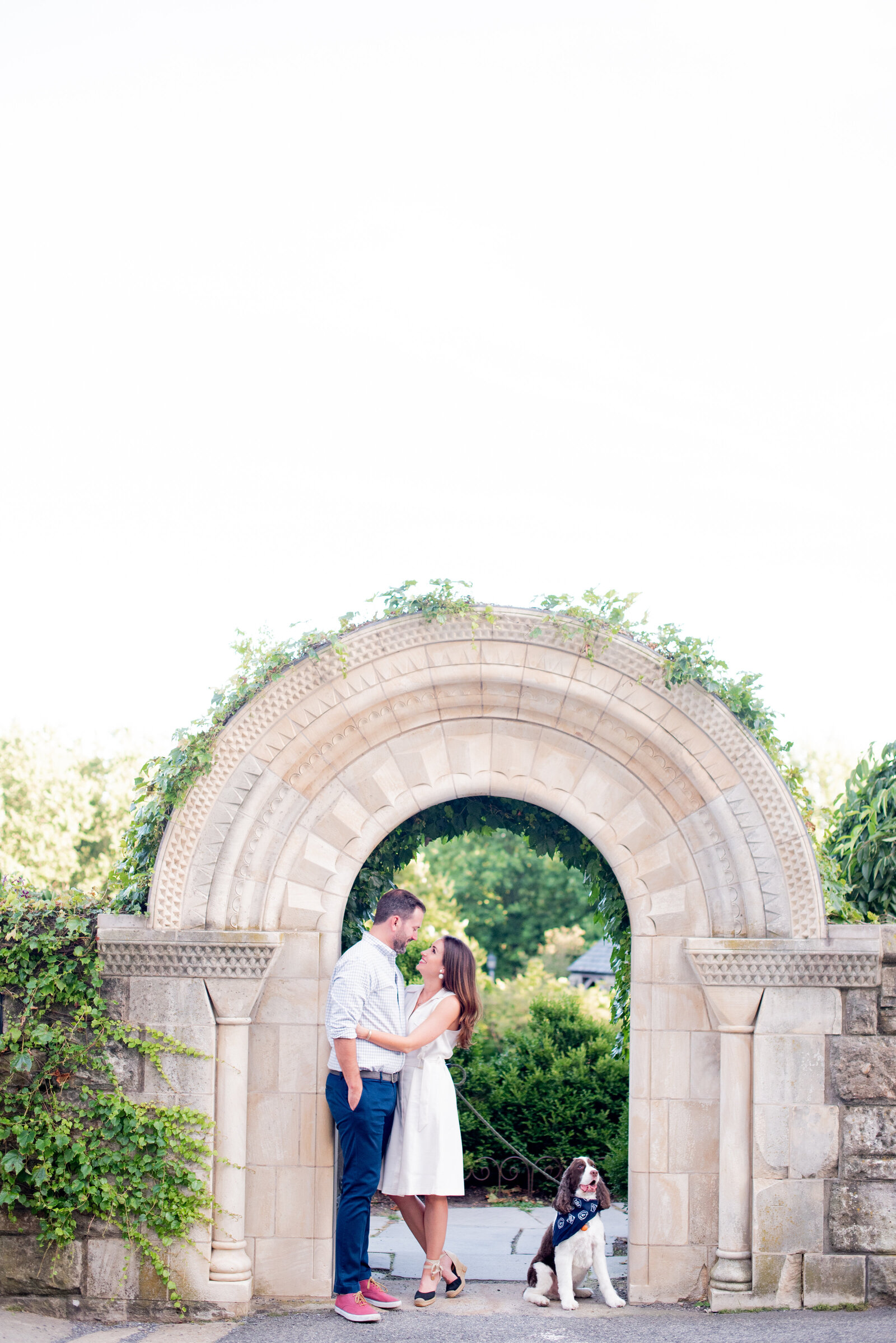 engaged couple taking engagement photos at National Cathedral engagement session