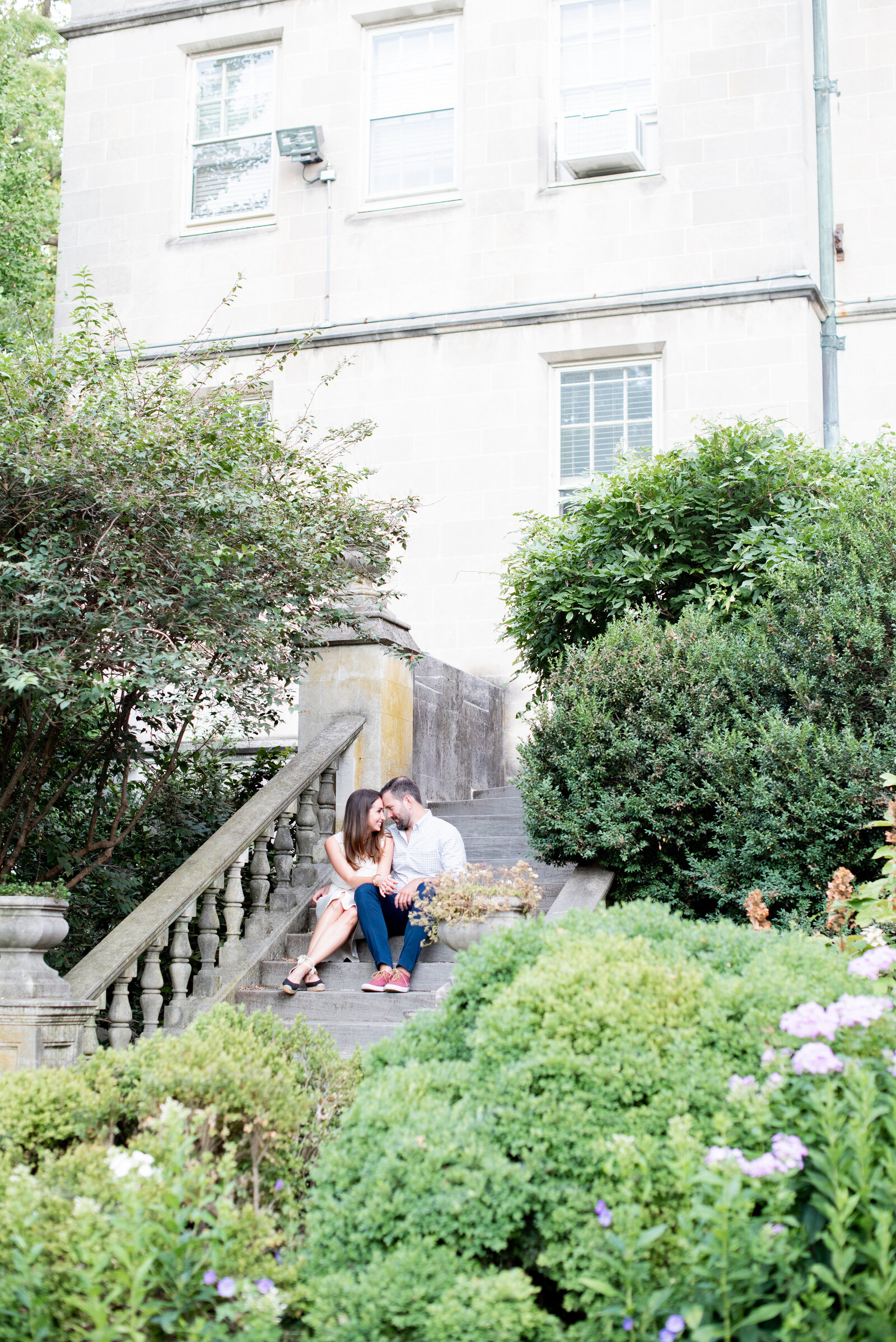 engaged couple taking engagement photos at National Cathedral engagement session