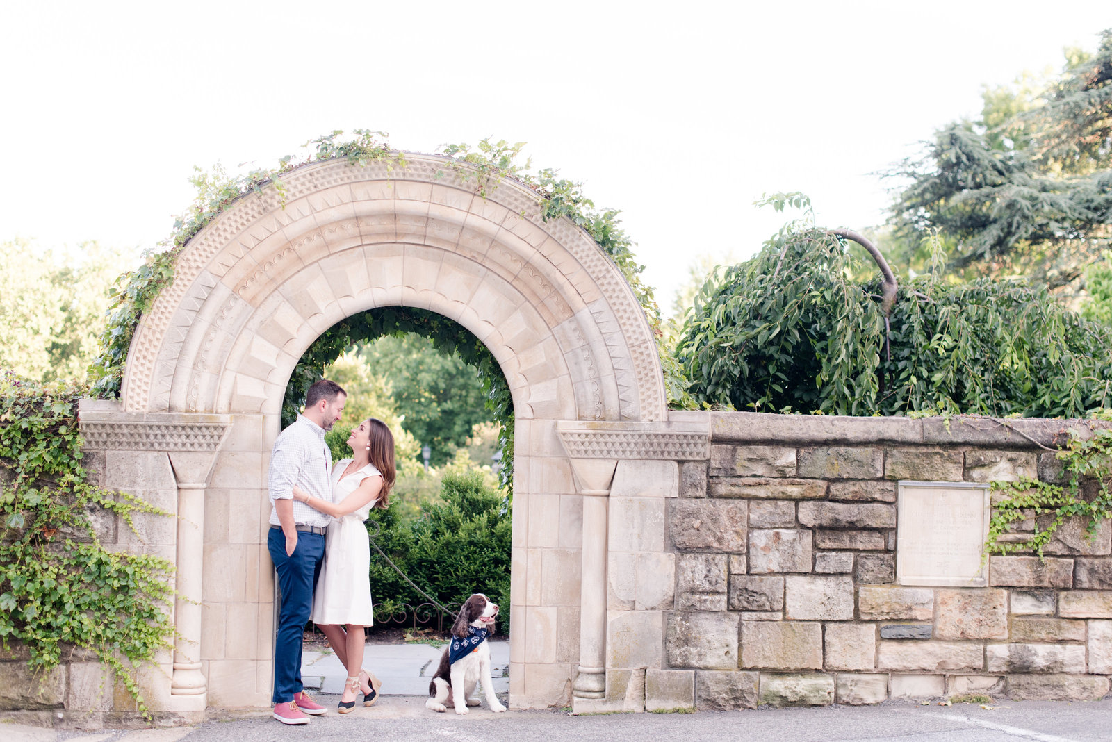 engaged couple taking engagement photos at National Cathedral engagement session